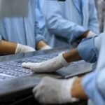 Workers in a pharmaceutical facility packaging tablets in Islamabad.
