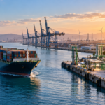 Container ship approaching a port equipped with green hydrogen and ammonia infrastructure, illustrating green shipping corridors.